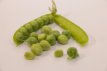 Green pea pod on a white background. sweet harvest of green peas,