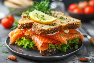 Delicious salmon or trout sandwich appetizer with fresh fish, bread, butter, and herbs