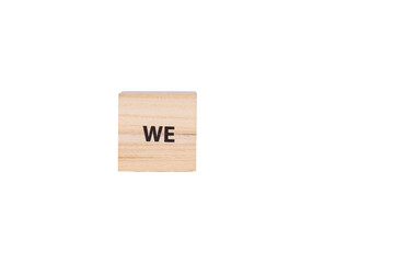 wooden cubes with the inscription We on a white isolated background close-up