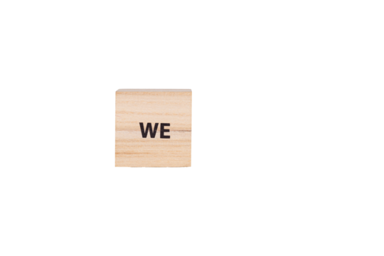 wooden cubes with the inscription We on a white isolated background close-up