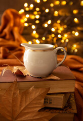 books, leaves, coffee cup and bokeh lights