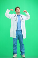 The doctor, in full height, on a green background, shows strength