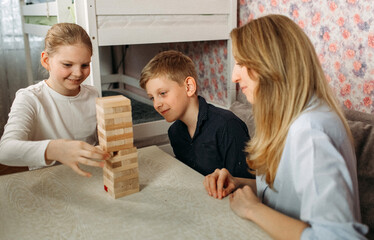 Woman and Two Children Playing With Wooden Blocks