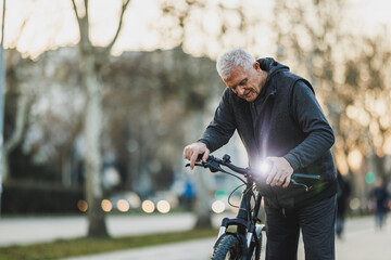 Senior Man Tuning His Bicycle in a Peaceful Park at Sunset