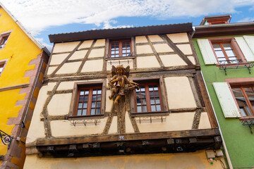 A wooden statue of an angel adorns the facade of a half-timbered building in the medieval old town of Riquewihr, France, one of France's "most beautiful" villages along the Alsatian Wine Route.