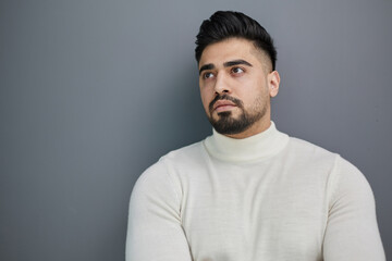 Obraz premium Portrait of stylish middle aged man posing on gray background