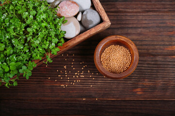 Freshly grown mustard microgreens in a rustic wooden box on wooden background, a healthy superfood concept.