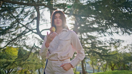 Beautiful woman standing park holding fresh apple closeup. Girl posing sunlight