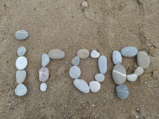 With the help of pebbles, Igor's name is represent on the sand