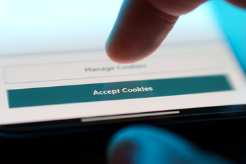 Accept cookies button on internet webpage on smartphone. Internet browsing history data technology...
