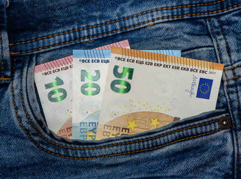 10, 20 and 50 euro bills coming out of the back pocket of a pair of jeans 1