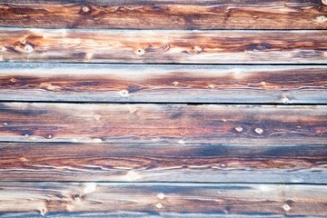 a pattern of wooden boards of a sitting bench in brown white color 