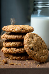 Healthy oat cookies and glass of milk on the wood table.