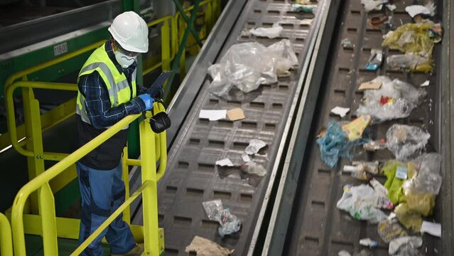 Supervisor Monitoring Conveyor Belts at Waste Management Facility