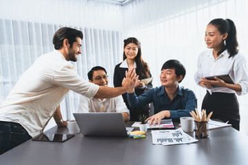 Diverse group of office employee worker high five after making agreement on strategic business...