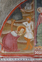 San Donnino decapitato regge la sua testa; affresco nella chiesa romanica di San Fedele a Como