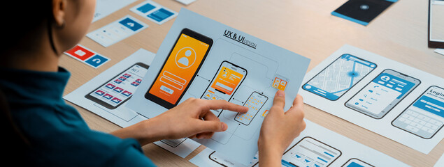 Panorama banner of startup company employee planning on user interface prototype for mobile...