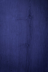 A blue wooden surface with a grainy texture. The color is deep and rich