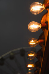 A row of light bulbs are lit up, creating a warm and cozy atmosphere. The bulbs are arranged in a...