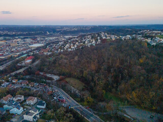 Aerial cityscape with forest at sunset during fall and residential Pittsburgh Pennsylvania