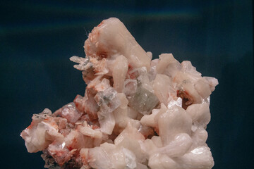 Red and white crystal mineral on the blue background vintage processing photo. Strange stone created by nature