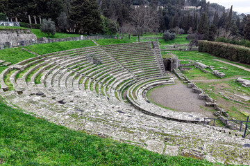 Fototapeta na wymiar The semicircular ancient Roman theatre at Fiesole, near Florence, Italy. It was built in late 1st c. BC and early AD and it's part of a great archaeological site including ruins of Etruscan era.