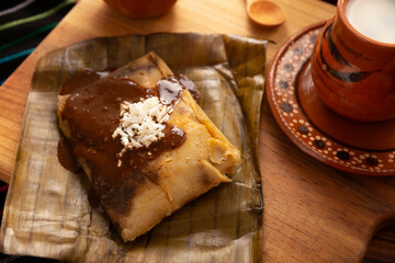 Oaxacan Tamale. Prehispanic dish typical of Mexico and some Latin American countries. Corn dough wrapped in banana leaves. The tamales are steamed.