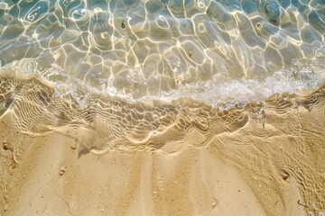 Fototapeta na wymiar A wave rolling onto a sandy beach, perfect for vacation ads