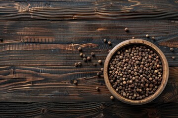A wooden bowl filled with peppercorns on a table. Suitable for food and cooking concepts
