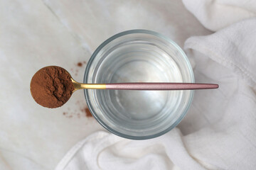 Unsweetened dark chocolate cacao powder in the spoon	