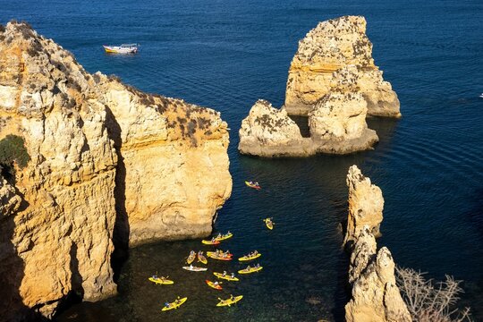 Kayaks between rocks in the Atlantic Ocean on the coast of Portugal - Benagil area