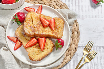 Plate with French toast, strawberries delicious food on dishware