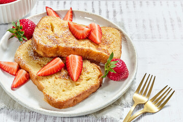 Plate with French toast, strawberries delicious food on dishware