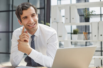 Image of successful businessman 30s thinking and holding index finger at forehead