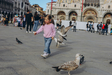 the child walks on St. Peter square in Vatican city center of Rome Italy,