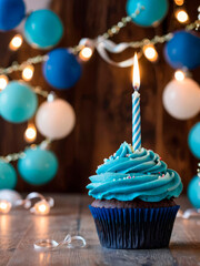 Happy birthday blue cupcake with burning candle, balloons and festive garlands in the background