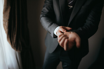 Guy is getting dressed for a business meeting.