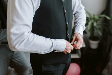 Guy is getting dressed for a business meeting.