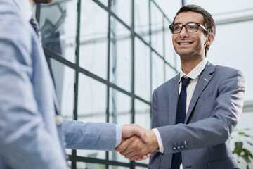 Business partners shake hands in the office