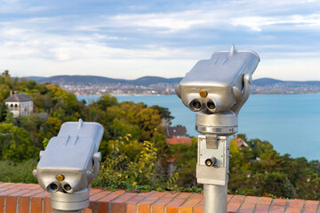 Binoculars displayed for tourists at a scenic lookout point by Lake Balaton in Hungary