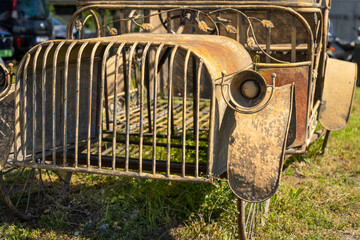 Car assembled from rusty metal in sunlight