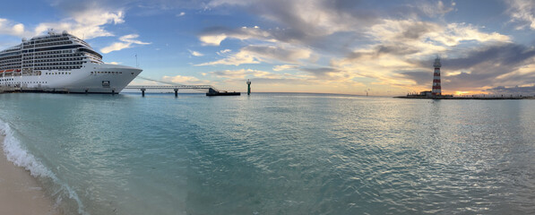 Panoramic shot of a cruise ship anchored on a Bahamian beach. Banner for tourism and travel...