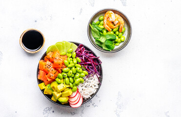 Poke bowl for balanced nutrition with salmon, avocado, radish, cabbage, edamame beans and rice, white table background, top view - 793288715