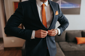 Guy is getting dressed for a business meeting. - obrazy, fototapety, plakaty