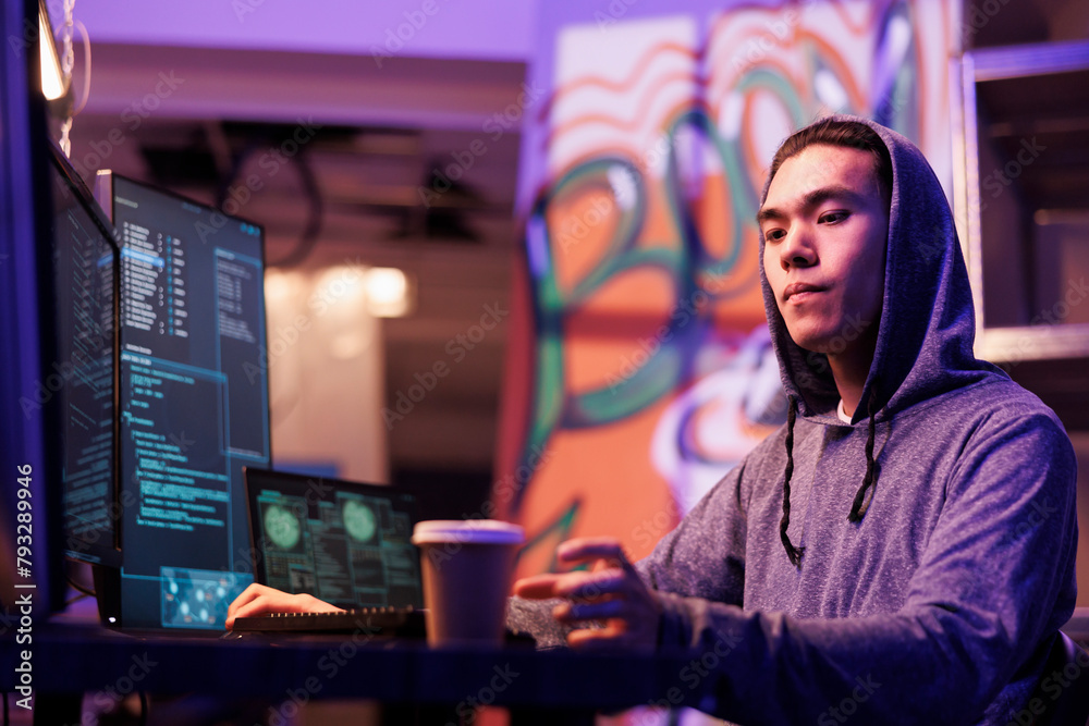 Poster asian hacker drinking coffee to go and hacking computer network system. internet criminal in hood ta