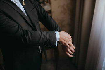 Guy is getting dressed for a business meeting.