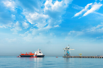 Maritime pilots dock lpg ship at the port pier. A gas carrier, gas tanker, LPG carrier, or LPG...