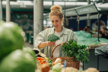 Happy customer choosing healthy food at greengrocery market.