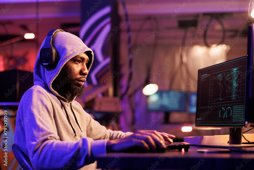 Poster hacker in headphones writing malware code and typing on keyboard. internet criminal in hood listenin