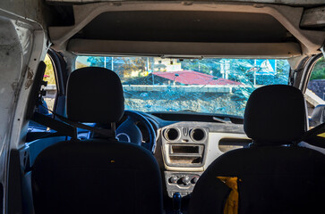 This image captures the interior of a car with a severely cracked windshield, illustrating the...